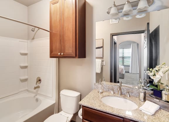 a bathroom with a sink toilet and shower and a mirror at Kingston Crossing Apartment Homes, Bossier City, LA, Louisiana  , 71111
