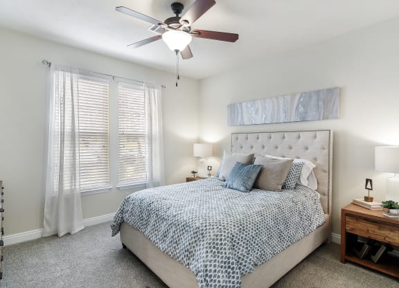 a bedroom with a bed and a ceiling fan at Charleston Apartment Homes, Mobile