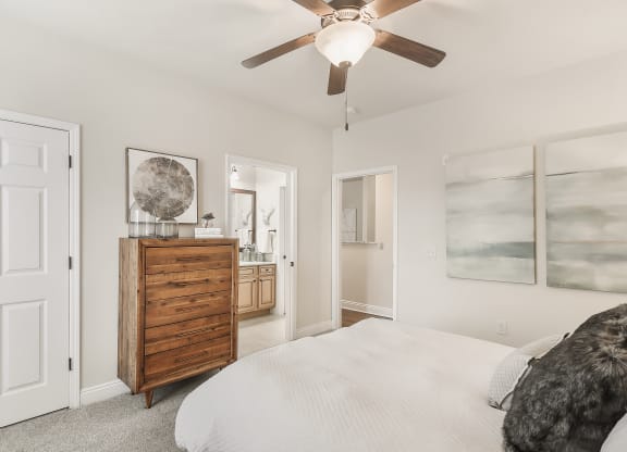 a bedroom with a bed and a ceiling fan at Charleston Apartment Homes, Mobile, Alabama