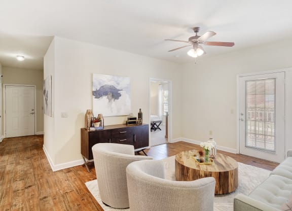 a living room with furniture and a ceiling fan at Summit of Shreveport Apartments, Shreveport