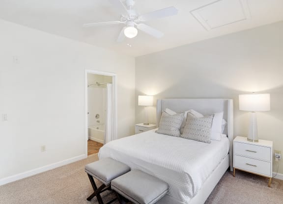 a bedroom with a large bed and a ceiling fan at Summit of Shreveport Apartments, Shreveport, Louisiana