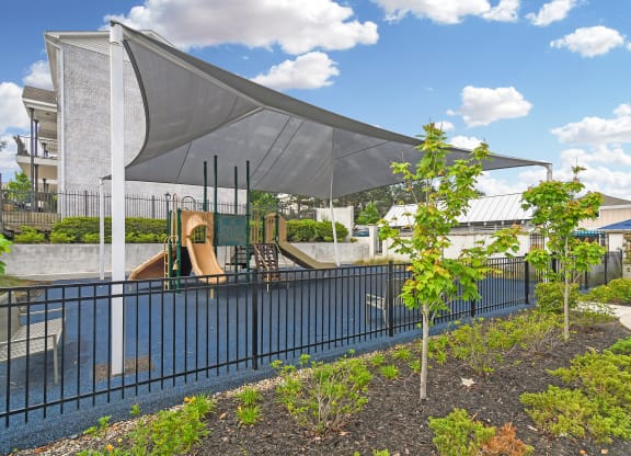 a pool with a canopy over it next to a building at Parkwest Apartment Homes, Mississippi