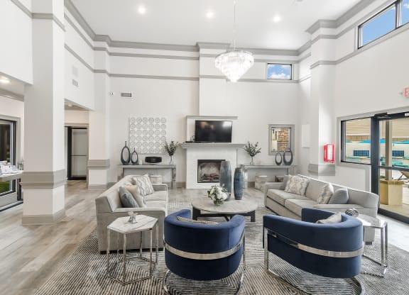 a living room with couches and chairs and a fireplace at Parkwest Apartment Homes, Hattiesburg, Mississippi