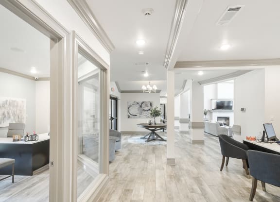 a living room and dining room with white walls and wood floors at Parkwest Apartment Homes, Hattiesburg, 39402