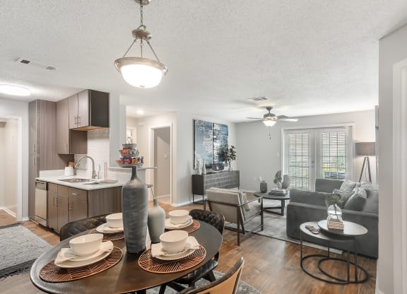 a living room and dining room with a table and chairs at Parkwest Apartment Homes, Hattiesburg, MS