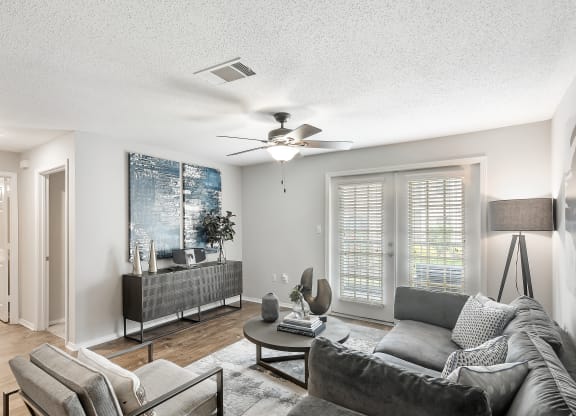 a living room with a couch and a ceiling fan at Parkwest Apartment Homes, Hattiesburg, 39402