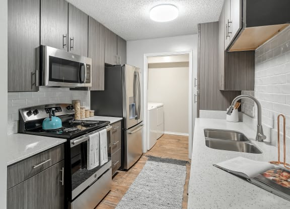 a kitchen with stainless steel appliances and a sink at Parkwest Apartment Homes, Hattiesburg, MS, 39402
