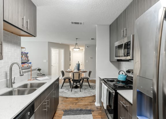 our spacious kitchen and dining room are open to the living room and family room at Parkwest Apartment Homes, Hattiesburg