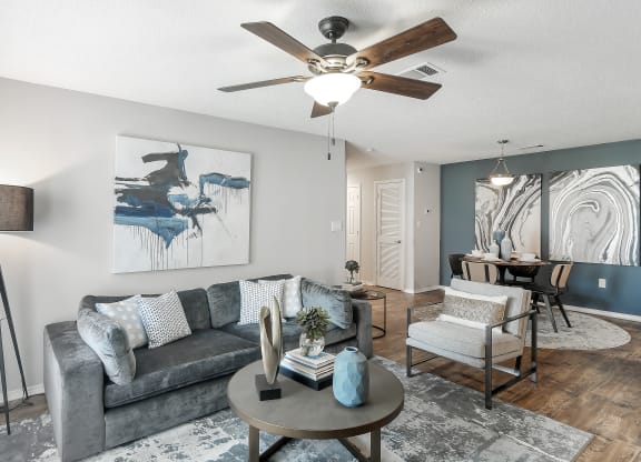 a living room with a ceiling fan and a couch at Parkwest Apartment Homes, Hattiesburg, MS, 39402