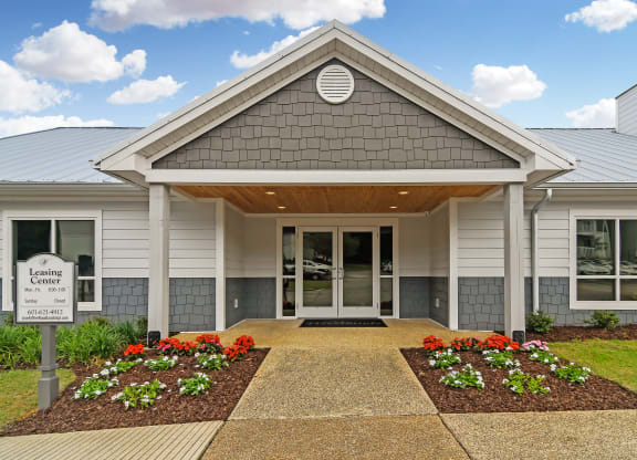 the exterior of a building with a sign in front of it at The Woodlands Apartment Homes, Meridian, MS, 39301