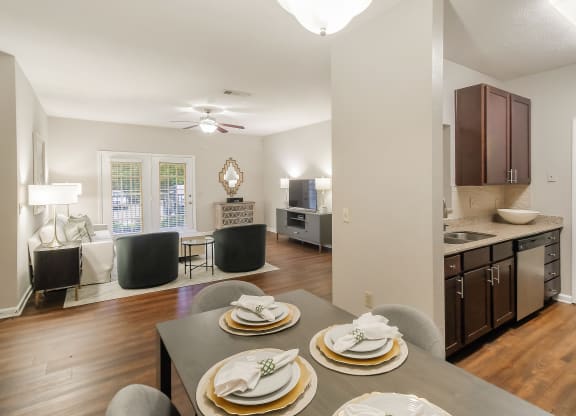 Open living room and kitchen with a dining room table and chairs at Highpointe Apartment Homes, Brandon, MS, 39042