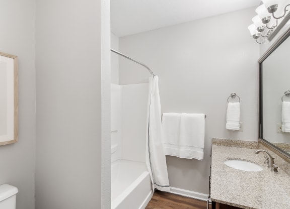 Bathroom with a shower and a sink and a mirror at Highpointe Apartment Homes, Brandon, MS