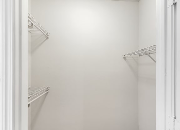 Walk in closet with two empty shelves at Highpointe Apartment Homes, Brandon