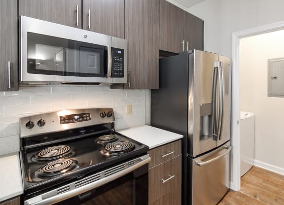 a kitchen with stainless steel appliances and a refrigerator at Legacy Apartment Homes in Ridgeland, 39157