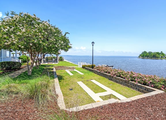 a view of the water from a park next to a lake at Lakeshore Pointe Apartment Homes, Mississippi, 39047