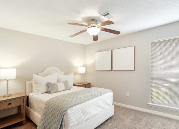 a bedroom with a bed and a ceiling fan at Lakeshore Pointe Apartment Homes, Mississippi, 39047