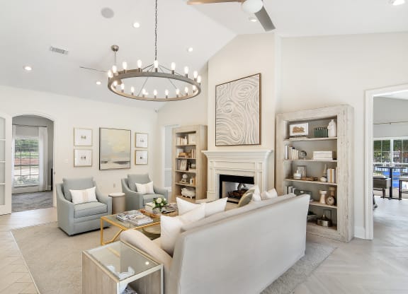 a living room with couches and chairs and a fireplace at Bridgewater Apartment Homes, Brandon