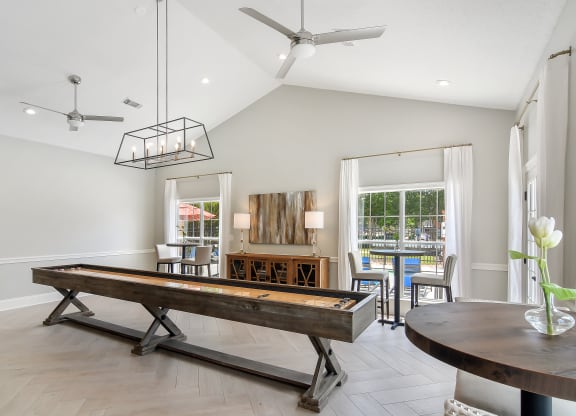 a living room with a pool table and a dining table at Bridgewater Apartment Homes, Brandon, MS 39047