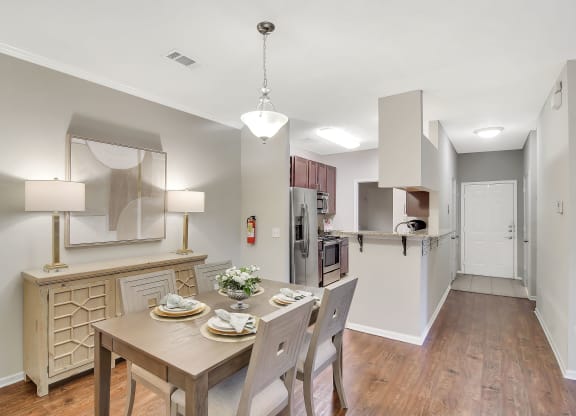 a kitchen and dining room with a table and chairs at Ashford Place Apartment Homes, Mississippi