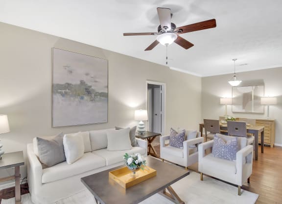 a living room with a ceiling fan and a couch at Ashford Place Apartment Homes, Flowood, MS