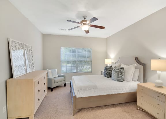 a bedroom with a bed and a ceiling fan at Ashford Place Apartment Homes, Flowood, 39232