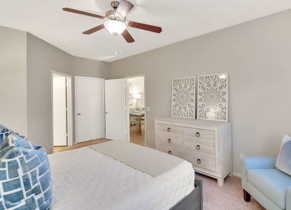 a bedroom with a large bed and a ceiling fan at Ashford Place Apartment Homes, Mississippi 39232