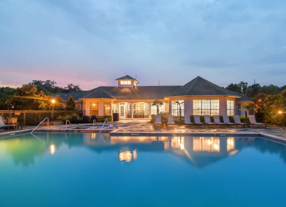 a swimming pool with a house in the background at Ashford Place Apartment Homes, Flowood, 39232