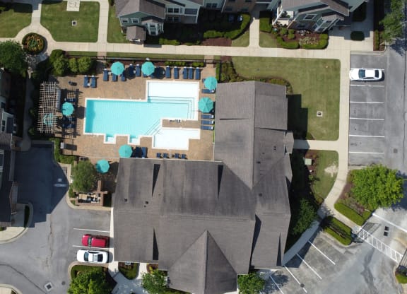 an aerial view of a neighborhood with a swimming pool in the middle of two houses at Audubon Park Apartment Homes, Louisiana