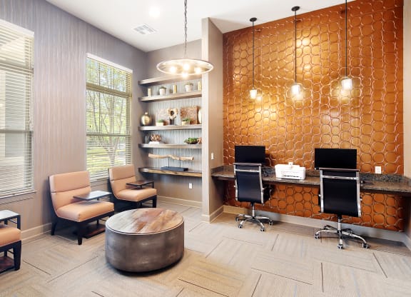 a business center with two desks and chairs and a round table at Audubon Park Apartment Homes, Louisiana
