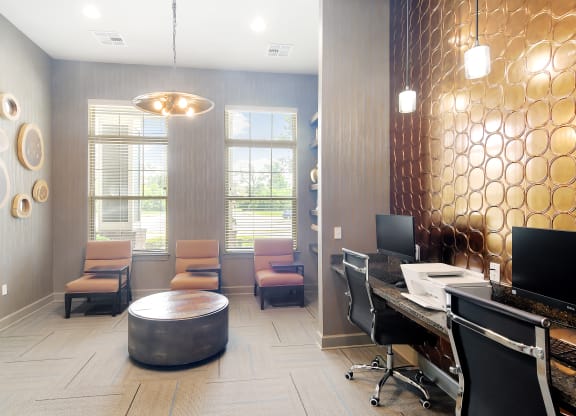 a reception area with a desk and chairs and a window at Audubon Park Apartment Homes, Louisiana