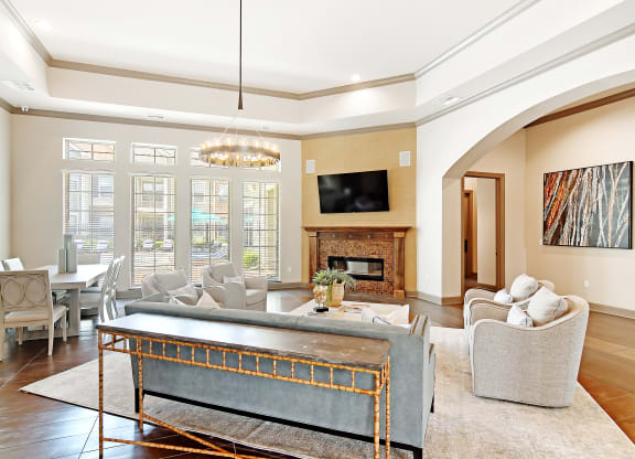 a living room with a fireplace and a table at Audubon Park Apartment Homes, LA