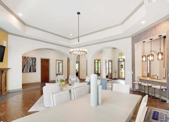 a large living room with a white table and chairs and a fireplace at Audubon Park Apartment Homes, Louisiana, 70791