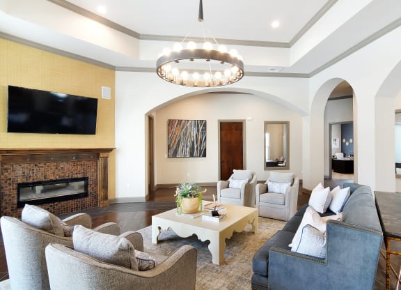 a living room with couches and chairs and a fireplace at Audubon Park Apartment Homes, Zachary, 70791