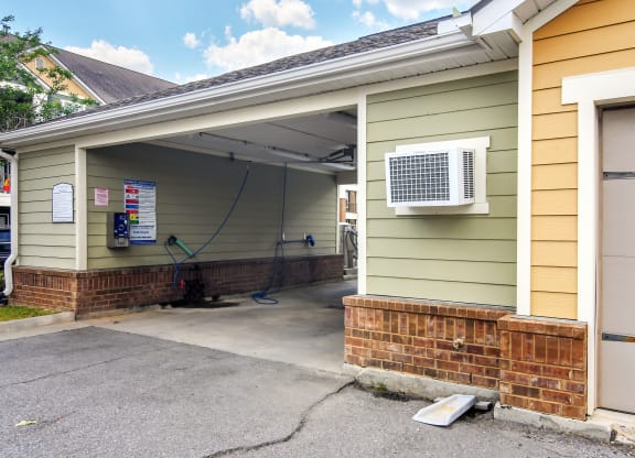 a garage with an air conditioning unit on the side of a house at Audubon Park Apartment Homes, Louisiana