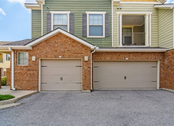 two garage doors on the side of a house at Audubon Park Apartment Homes, Zachary, Louisiana, 70791