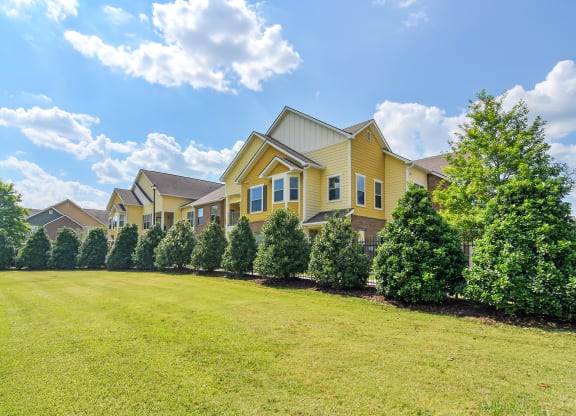 a row of houses with trees in front of them at Audubon Park Apartment Homes, LA