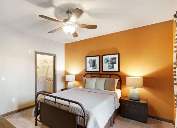 a bedroom with a large bed and a ceiling fan at Audubon Park Apartment Homes, Zachary, 70791