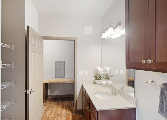 a bathroom with a sink and a mirror and a door to a toilet at Audubon Park Apartment Homes, LA