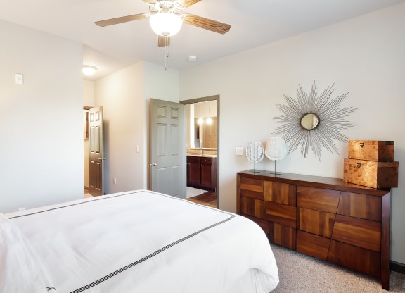 a bedroom with a large white bed and a ceiling fan at Audubon Park Apartment Homes, Louisiana, 70791
