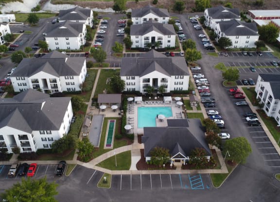 an aerial view of a neighborhood of houses with a swimming pool at Avalon Apartment Homes, Mississippi, 39759