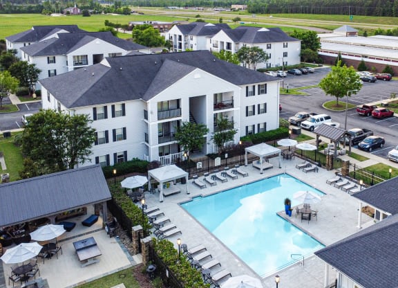 an aerial view of a swimming pool in the center of an apartment complex at Avalon Apartment Homes, Starkville, Mississippi, 39759