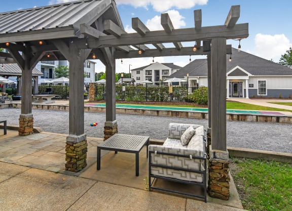 a patio with a couch and a table under a gazebo at Avalon Apartment Homes, Starkville, Mississippi