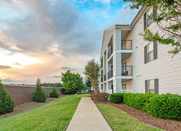  exterior view of apartments with sidewalk and grass at Avalon Apartment Homes, Starkville, 39759