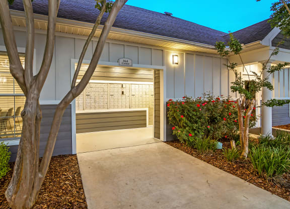 a walkway leading to a garage door of a house at Avalon Apartment Homes, Starkville, MS, 39759