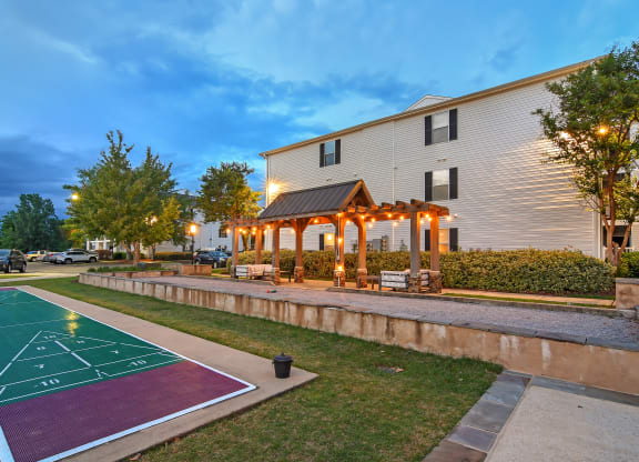the pavilion at twilight at the community with a basketball court at Avalon Apartment Homes, Starkville, MS