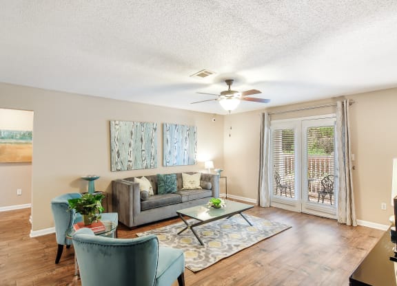 a living room with a couch and a ceiling fan at Avalon Apartment Homes, Starkville, MS, 39759