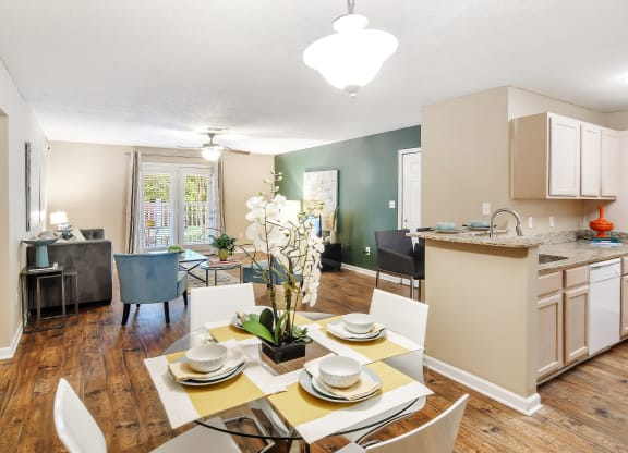 a kitchen and dining room with a table and chairs at Avalon Apartment Homes, Mississippi, 39759