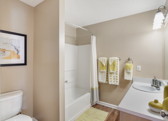 a bathroom with a shower and a toilet and a sink at Avalon Apartment Homes, Starkville, MS, 39759