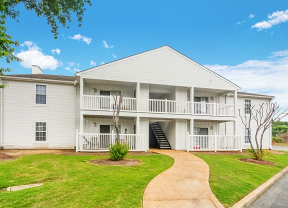 a white house with a walkway in front of it at The Oliver Apartment Homes, Mississippi, 38654