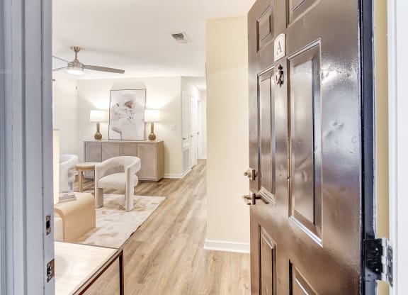 an open door leading to a living room and a dining room at The Oliver Apartment Homes, Olive Branch, MS, 38654